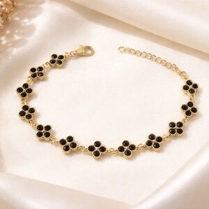 14k gold and black onyx bracelet with clover design